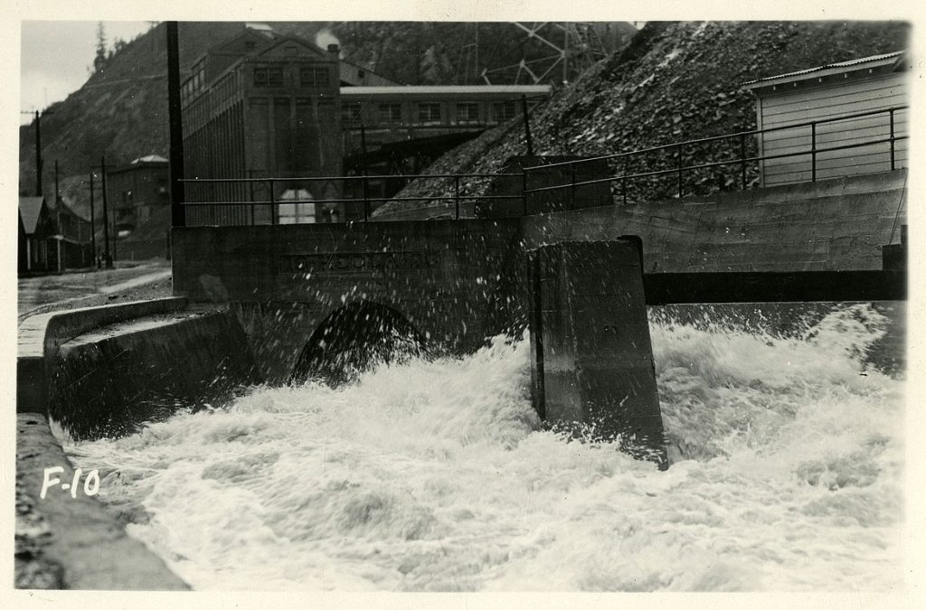 High water event on Canyon Creek with water travelling through the main culvert near Burke, Idaho