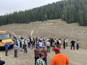 A group of people are at a remediation site for a tour.