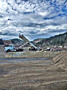 Dump truck offloading material at Page.