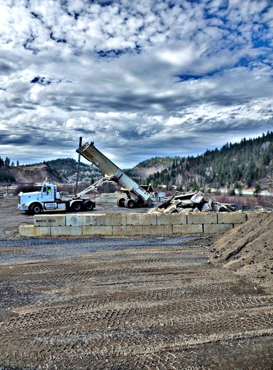 Dump truck offloading material at Page.
