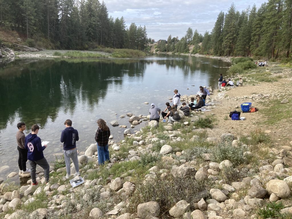 Students gather macroinvertebrates during a water quality field day as part of the Confluence Project